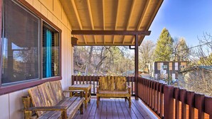 A wooden deck with benches and a table, overlooking a wooded area. - Patio, Grill + Mogollon Rim Views: Payson Cabin (Payson)