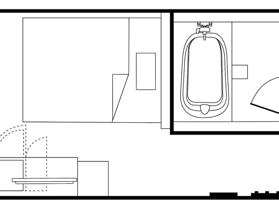 A floor plan of a hotel room with a bed, a desk, a chair, a bathroom with a toilet, sink, and shower.