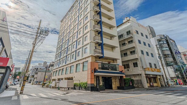A multi-story hotel with a prominent "APAHOTEL" sign, a modern architectural design, and a clear sky. - APA Hotel Naha Airport Wakasa (Naha)