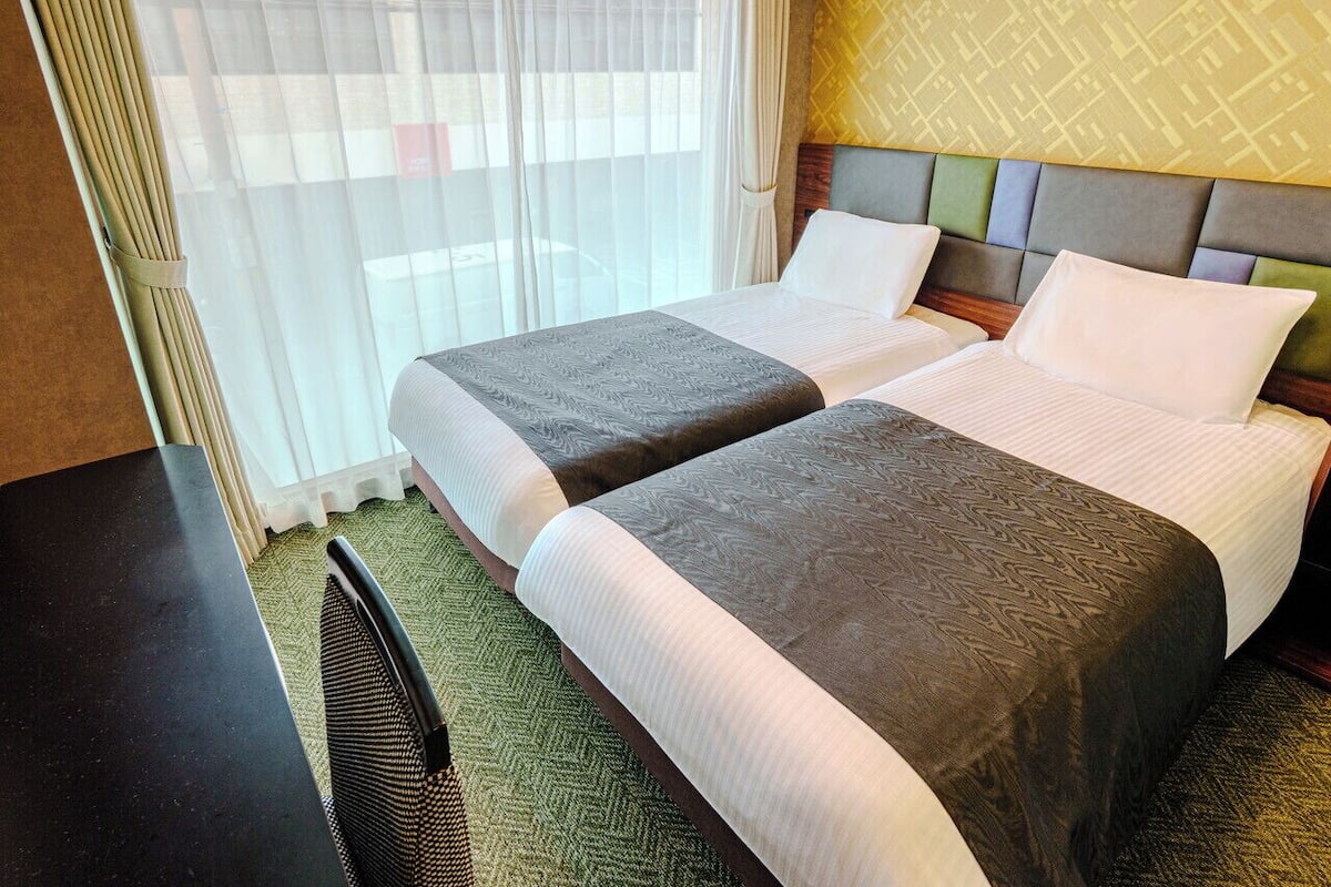 Twin Room, Non Smoking | Down comforters, desk, free WiFi, bed sheets