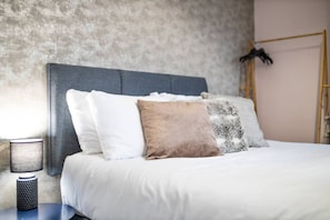 Comfortable retreat with a large bed and functional workspace.