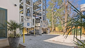 A multi-story parking structure with cars parked on different levels. - The Iris, Signature Suite (Charleston)