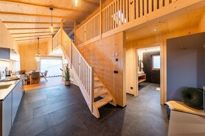 A wooden interior with a staircase, a kitchen area, and a bathroom. - Farmhouse 'Waldruhe' with Mountain View, Shared Garden and Wi-Fi (Latzfons/Klausen)