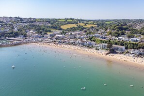 An aerial view of a coastal town with a beach, houses, and boats. - Plas Gwyn - Walk to Beach Parking Enclosed Garden (Saundersfoot)
