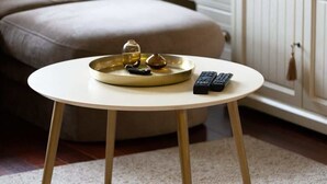 A round table with a tray, remote controls, and a glass on it. - Comfortable Apartment in Gdynia | 2 Bedrooms | Parking (Gdynia)