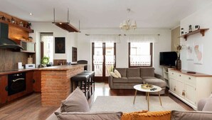 A modern living space with a kitchen, a dining area, and a seating area with a sofa and a coffee table. - Comfortable Apartment in Gdynia | 2 Bedrooms | Parking (Gdynia)