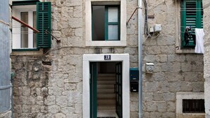 A stone building with a numbered door, a visible staircase, and a small window with shutters. - Dominus, Modernly Decorated Suite in City Center (Split)