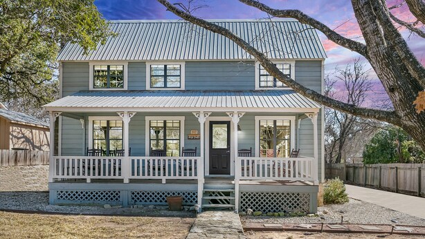 A two-story house with a porch, a front door, and a number '207' sign.