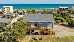 A coastal residential area with houses, a wooden deck, and a view of the ocean. - Private Coastal Haven - 2nd Row, Spectacular views (Emerald Isle)