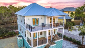 A two-story house with a balcony, a porch, and a deck. - Paradise | Oceanview, Hottub, Shuffleboard, Bikes, Beach, Pool (Port St. Joe)