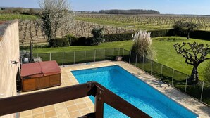 A swimming pool with a view of a vineyard in the background. - Beautiful Gite with pool and jacuzzi 6 pers 3 bedrooms (Nantille)