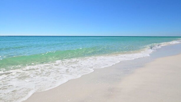 A beach with clear turquoise water and a sandy shore. - Hoosier Holiday 1 Bedroom Condo by RedAwning (Destin)