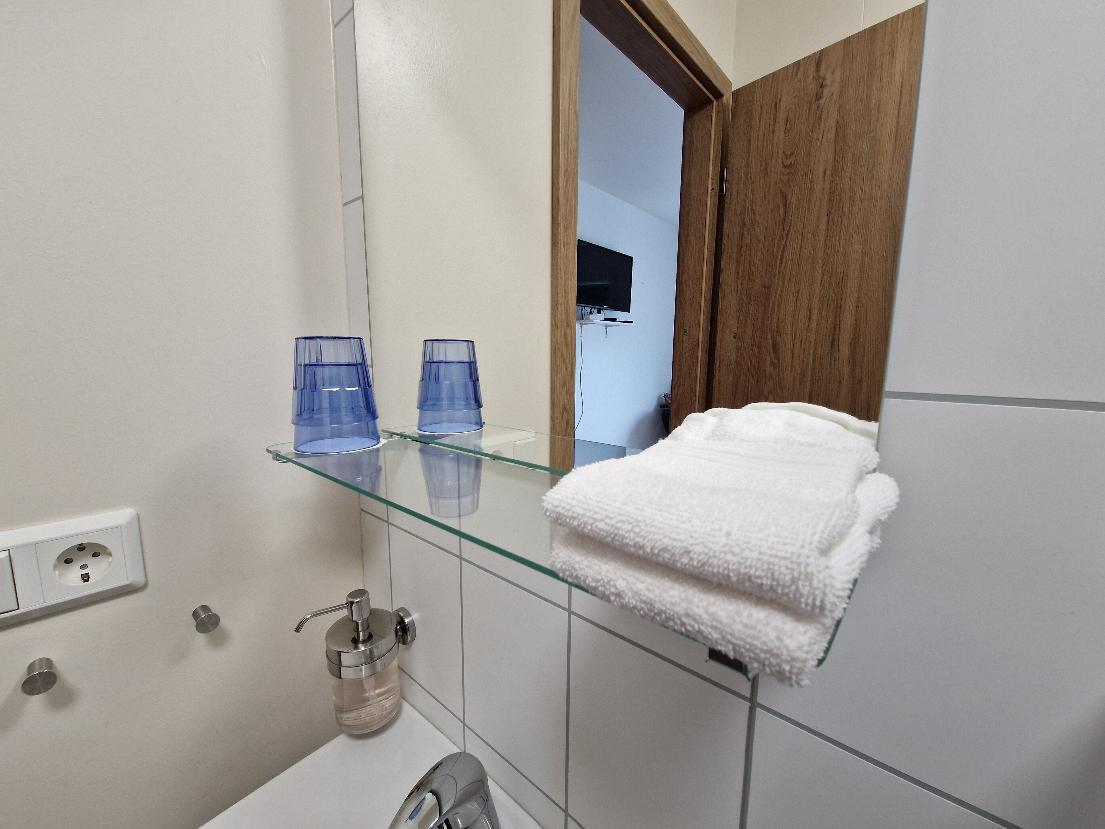 shower, rainfall showerhead, hair dryer, towels