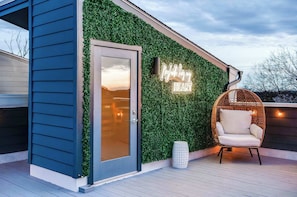A modern building with a green wall and a neon sign that reads "My Heart."