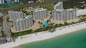 A coastal hotel complex with multiple high-rise buildings, a beach, and a swimming pool. - Silver Shells St Lucia 501 - Beachfront, Heated Community Pool + Hot Tub! (Destin)