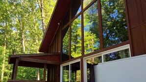 A hot tub with a clear view of the surrounding wooden deck and large windows. - Hocking Hills secluded Mayapple Cabin - 8 miles from Cantwell Cliffs! ~Hot Tub~ (Rockbridge)