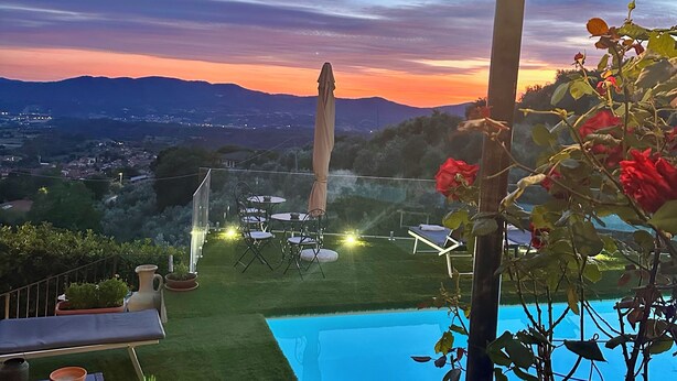 A pool area with lounge chairs, a lamp post, and a view of the landscape. - Villa Borgo Soale in Tuscany—Reggello. Private pool and Wi-Fi (Toscana)