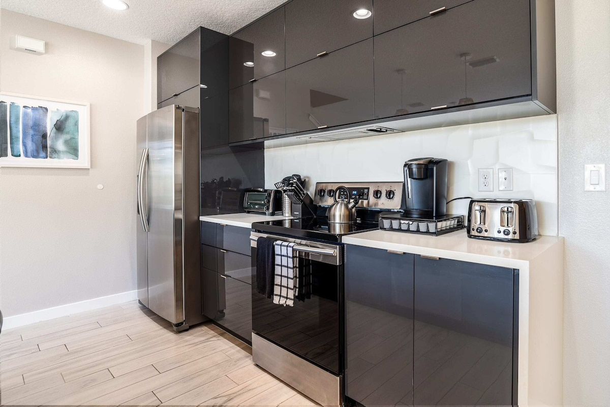 A modern kitchen with stainless steel appliances, a coffee maker, and a toaster.