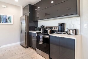 A modern kitchen with stainless steel appliances, a coffee maker, and a toaster.