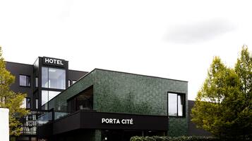 A modern building with a sign reading "HOTEL" and "PORTA CITÉ".