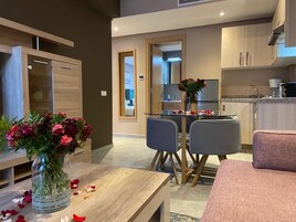 Deluxe Suite, 2 Queen Beds | Living area | 48-inch Smart TV with satellite channels, Netflix, streaming services