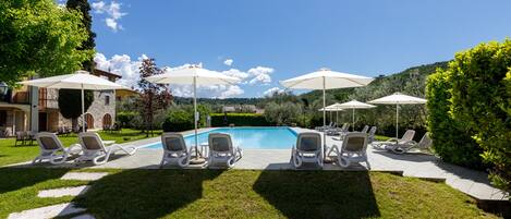 Seasonal outdoor pool, open 9:00 AM to 7:00 PM, pool umbrellas