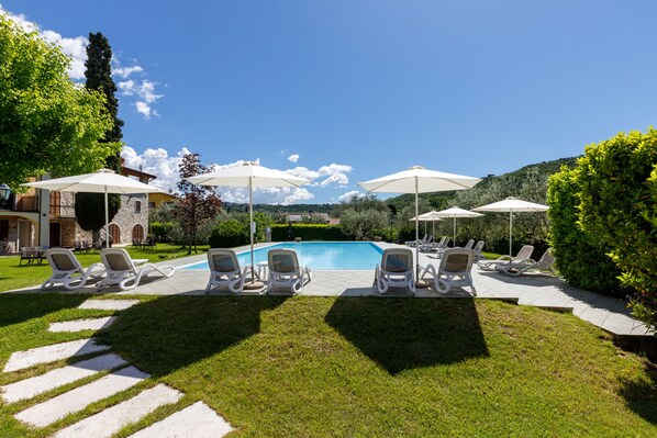 Seasonal outdoor pool, open 9:00 AM to 7:00 PM, pool umbrellas