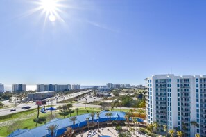 A high-rise hotel with a view of a cityscape and a parking area. - Beautiful, Updated 11th Floor Full Two Bedroom Condo at The Palms of Destin! (Destin)