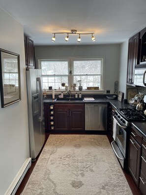 Enjoy cooking in this well-equipped kitchen with a gas stove, double sink, and ample storage.