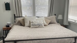 A bedroom with a bed, a bedside table, a lamp, and a window with curtains. - 1.5 miles to Mount Snow ski resort and minutes to area golf courses . (Dover)