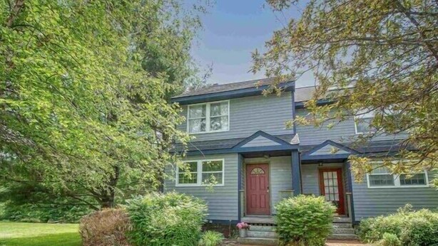 A two-story house with a front porch, a red door, and a brick pathway leading to the entrance. - 1.5 miles to Mount Snow ski resort and minutes to area golf courses . (Dover)