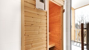 A wooden sauna room with a bench and a control panel. - Alm Lodge A2 - Tauplitz Lodges (Tauplitz)