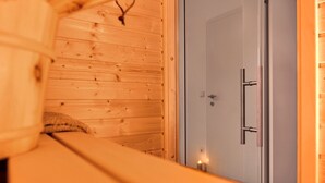 A wooden interior with a door and a small light on the floor. - Bergblick Lodge B6 - Tauplitz Lodges (Tauplitz)