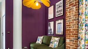 A modern living room with a green sofa, yellow chairs, and a unique yellow pendant light. - Appart indépendant, 2chambres!Parc des expositions (Paris)