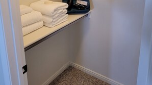 A walk-in closet with a hanging rod, shelves, and a folded towel rack. - CASITA NEAR ZION (Hurricane)