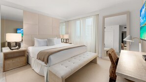 A modern hotel room with a large bed, bedside tables, a bench, and a TV. - Oceanview Private Condo at 1 Hotel & Homes -1211 (Miami Beach)