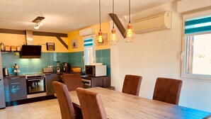 A modern kitchen with a dining area.