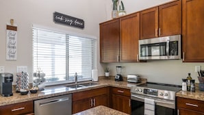A modern kitchen with granite countertops, stainless steel appliances, and wooden cabinets. - Scottsdale Family Escape: Golf, Pool and Spa (Scottsdale)