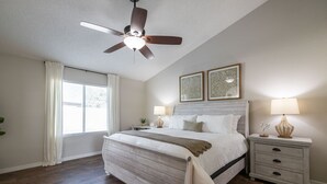 A bedroom with a bed, a nightstand, a ceiling fan, and two wall-mounted lamps. - Scottsdale Family Escape: Golf, Pool and Spa (Scottsdale)