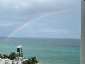 A view of a coastal area with a clear sky and a rainbow.