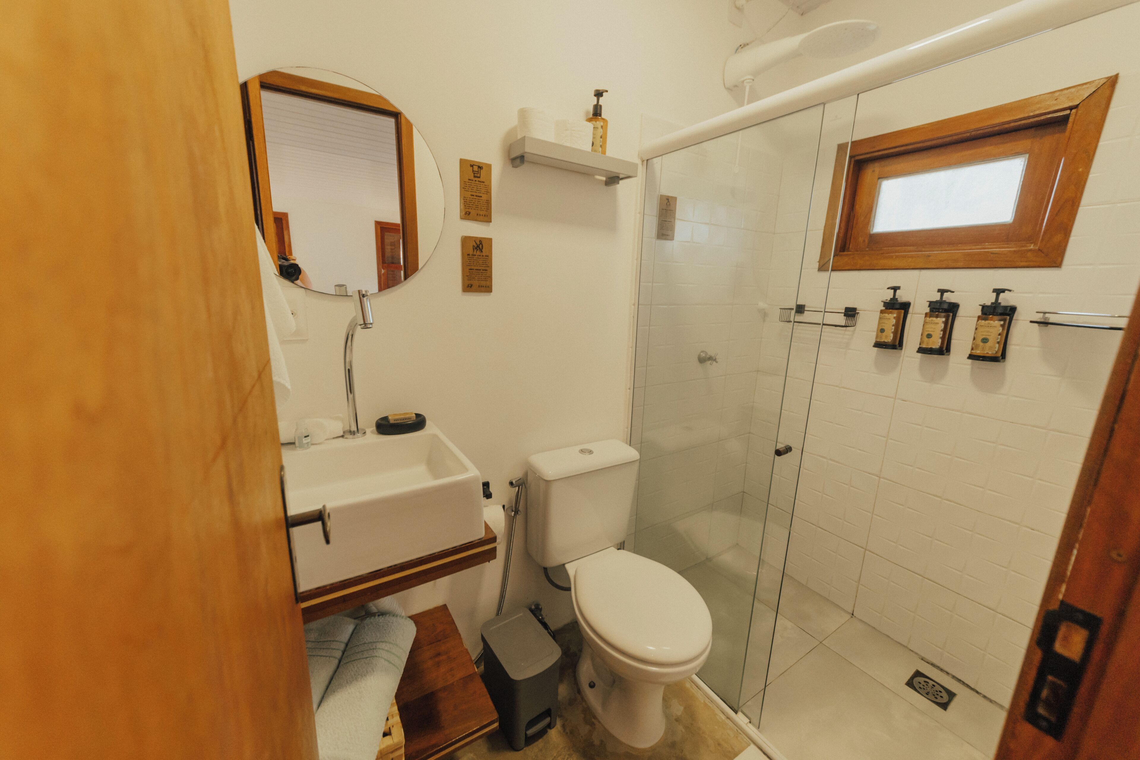 A bathroom with a toilet, sink, and shower area.