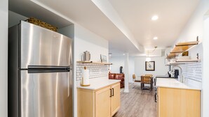 A modern kitchen with a stainless steel refrigerator, wooden cabinets, and a white countertop. - Riverfront Oasis with Mountain Views, close to town  (Middletown)