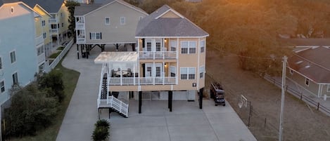 A two-story building with a balcony and a staircase leading to the upper floor.