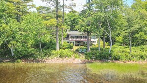 A house surrounded by dense trees and a body of water. - Waterfront Home -  Mid Coast Maine near Camden and Belfast (Belmont)