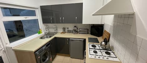 Microwave, coffee/tea maker, highchair, cookware/dishes/utensils