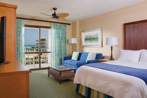 Relax in this spacious room with a large bed, ocean views, and a balcony with outdoor seating.