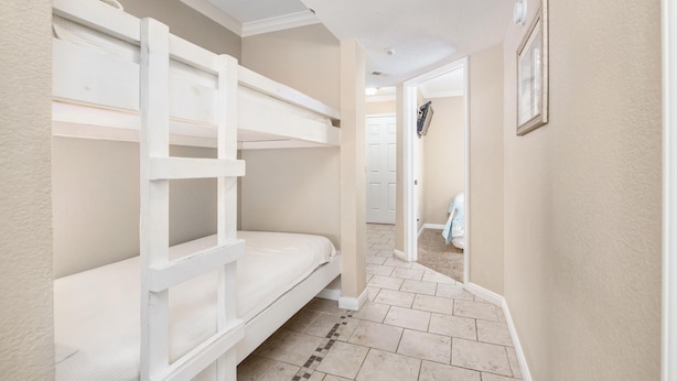 A bunk bed room with a hallway leading to another room. - Seascape 1321 in Galveston (Galveston)