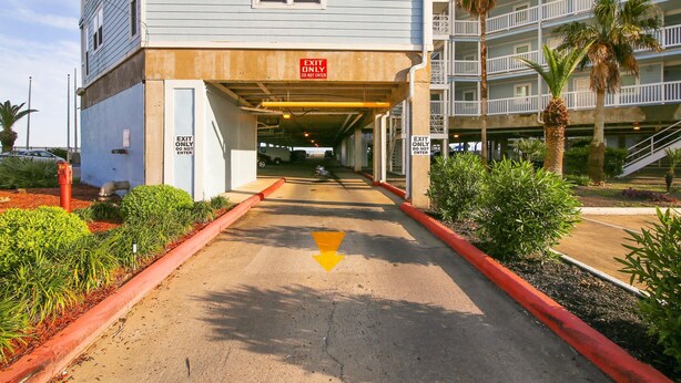 A building with an 'EXIT ONLY' sign above a covered walkway. - Seascape 1120 in Galveston (Galveston)