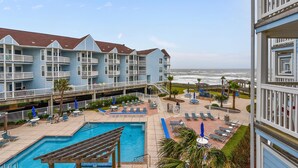 A hotel with a pool area, outdoor seating, and a view of the ocean. - Seascape 1216 in Galveston (Galveston)