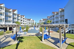 Guests can enjoy the resort's central courtyard with a water feature, surrounded by seating areas and palm trees.
